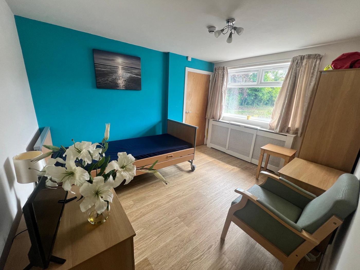 A bright resident bedroom with garden window