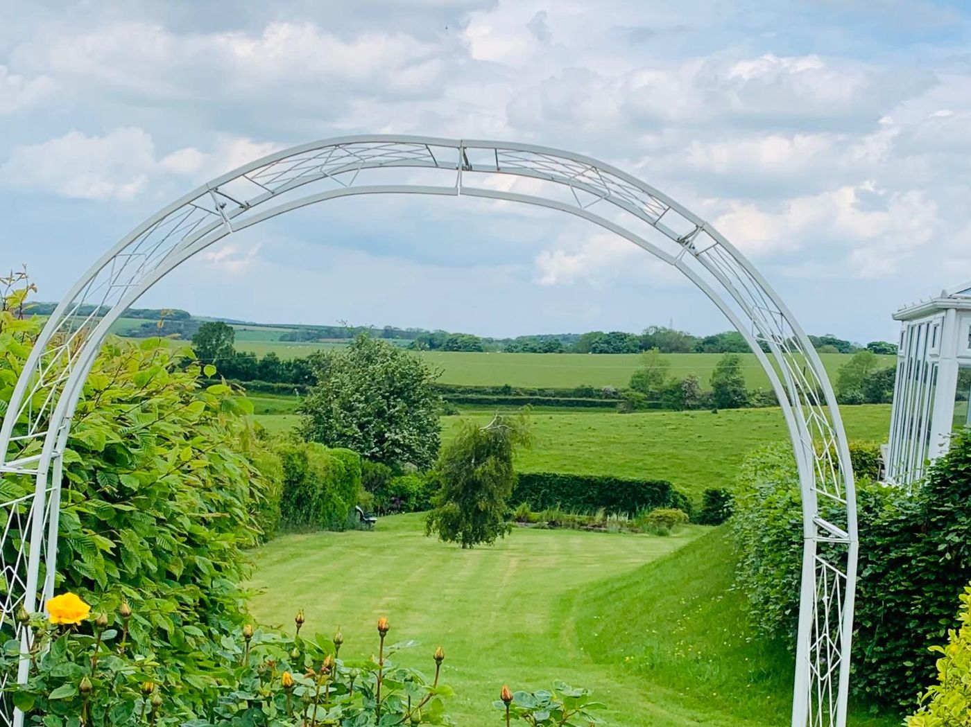 Countryside view through a garden arch