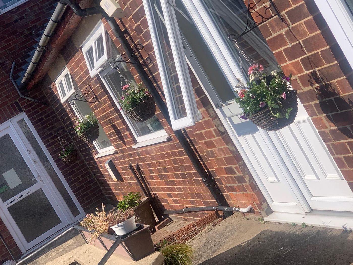 The front entrance with hanging baskets