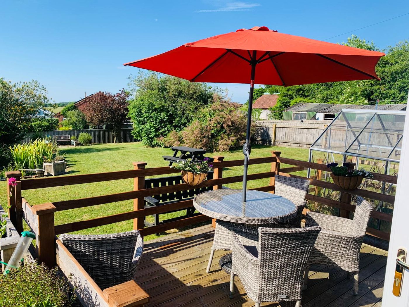 Garden patio with a parasol and seating