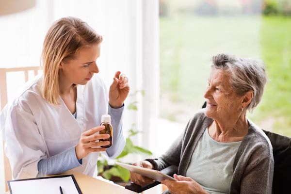 A nurse talking a resident through her medication