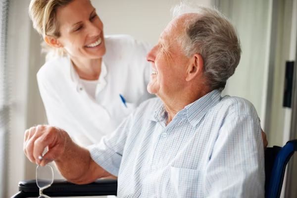 A smiling resident chatting with a carer