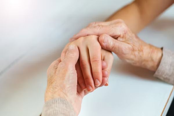 Two hands held together in comfort