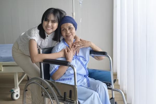 A carer embracing a resident in a wheelchair