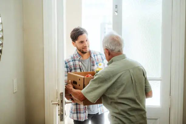 A visitor arriving with a delivery for a resident